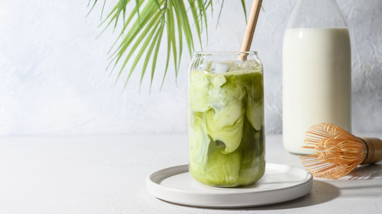 Iced matcha in glass with whisk