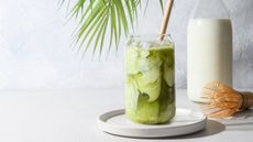 Iced matcha in glass with whisk