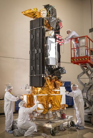 Lockheed Martin employees work on DMSP-19 during final integration at Vandenberg Air Force Base, Calif. The satellite was launched April 3, 2014 continuing a 50-year weather program for the Department of Defense.