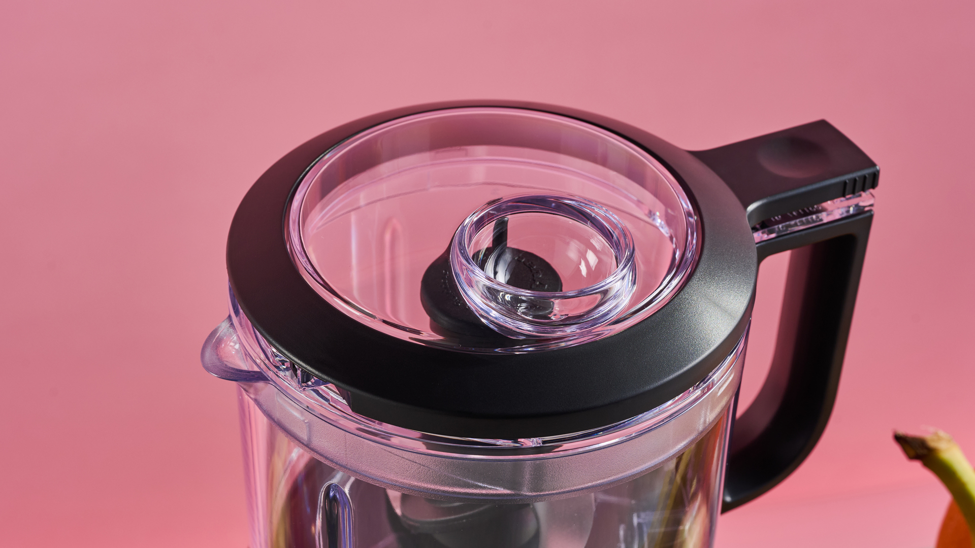 A close up of the KitchenAid Mini Food Chopper lid, showing the drizzle basin.