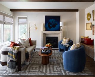 A neutral living room with accents of gold, yellow, blue and rust