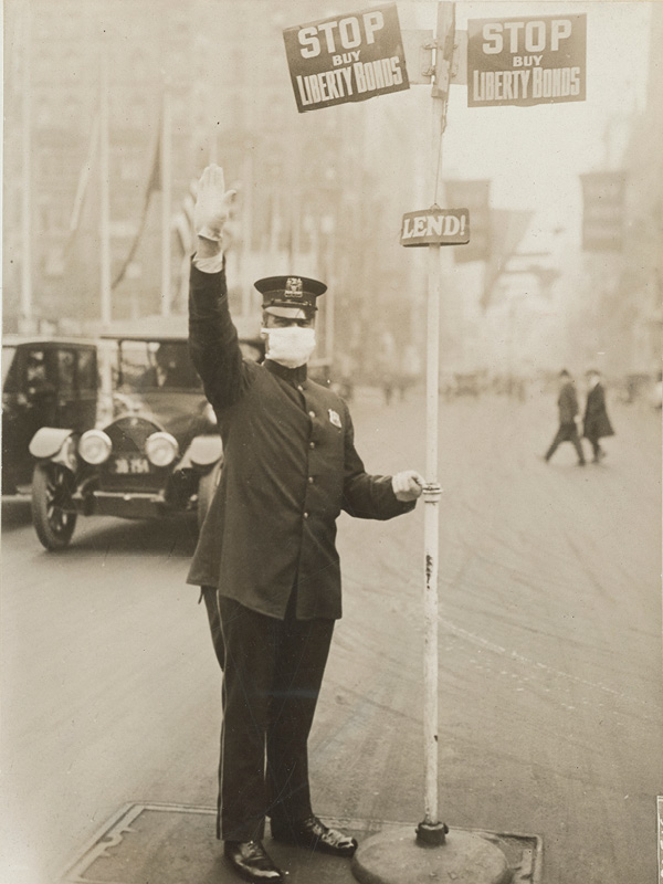 A police officer conducts traffic in New York during the Spanish flu pandemic, 1918