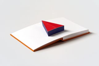Book spread with a 3D triangle leaping from its pages