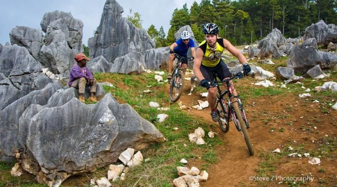 Racers fly through some rocky terrain in the Mountain Bike Ayiti