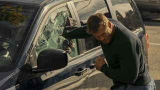 Jack Reacher punches through a car window in Reacher season 2