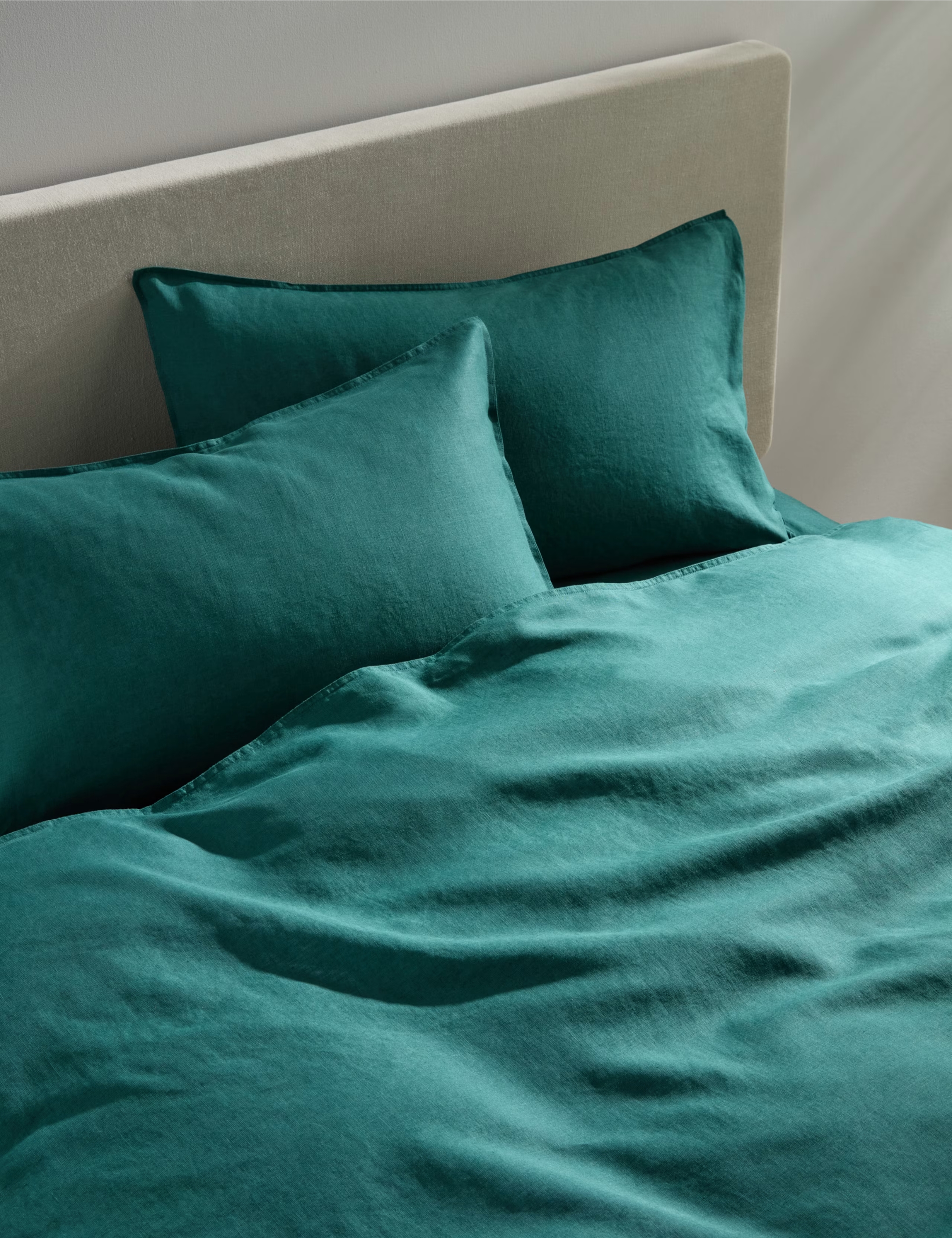 emerald green bedding on a bed