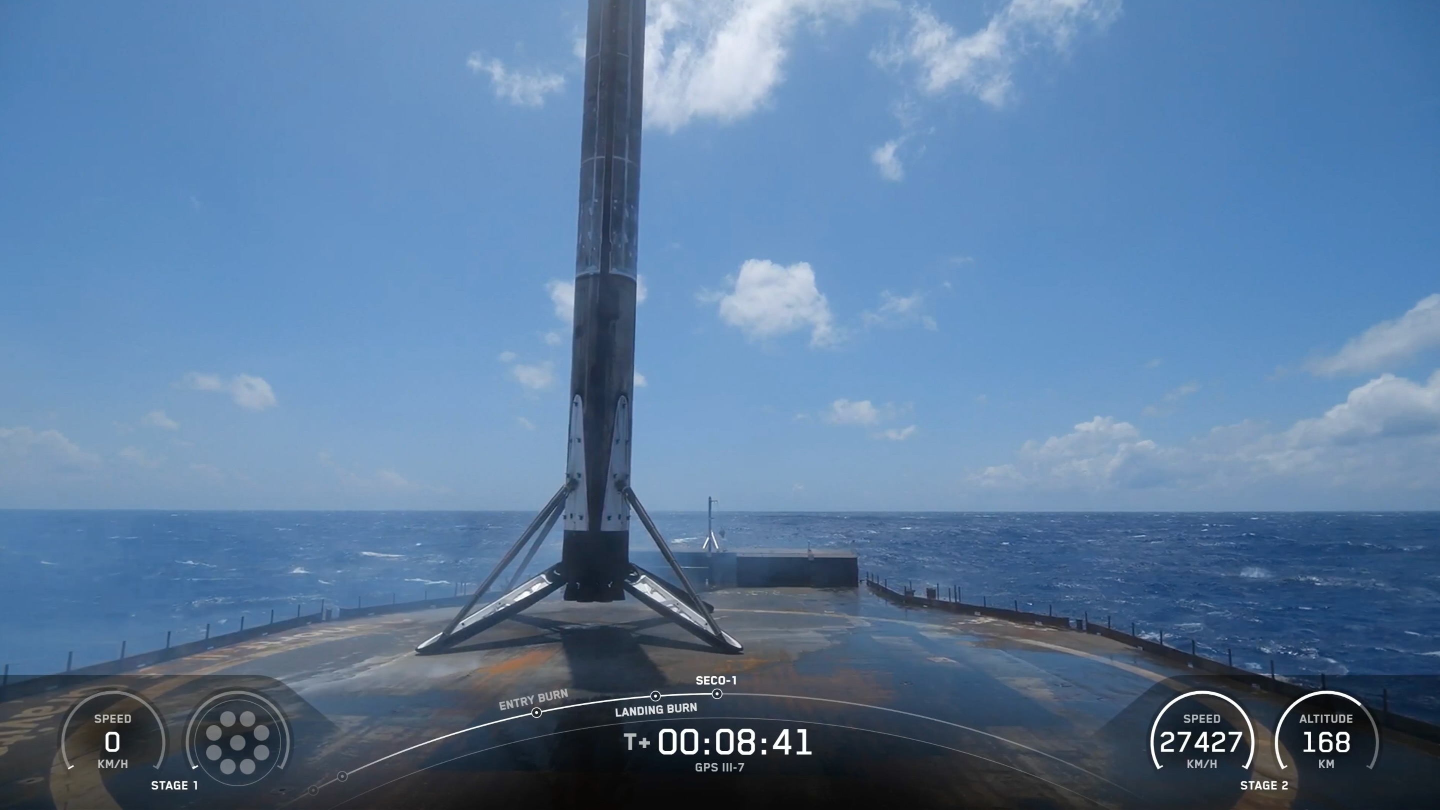 a rocket rests on the deck of a ship at sea under blue skies