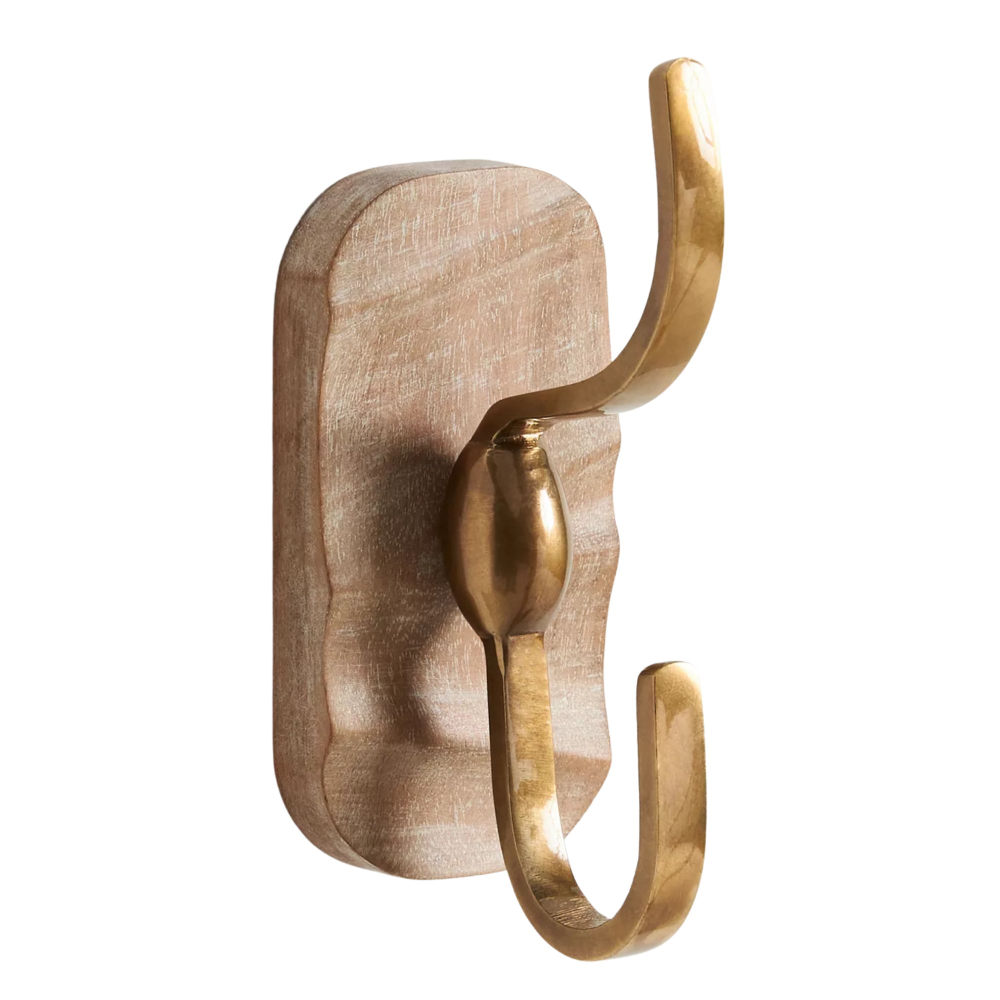 A gold wall hook mounted on a piece of wood.