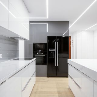 All white kitchen countertops with black fridge