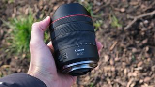 Canon RF 10-20mm F4L IS STM lens held in a hand
