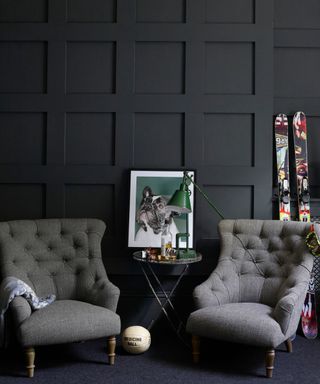 Dark grey wood panelled library reading room, pair of matching grey vintage armchairs