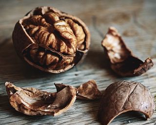 a walnut cracked open on a wood table