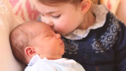Princess Charlotte kisses her brother Prince Louis
