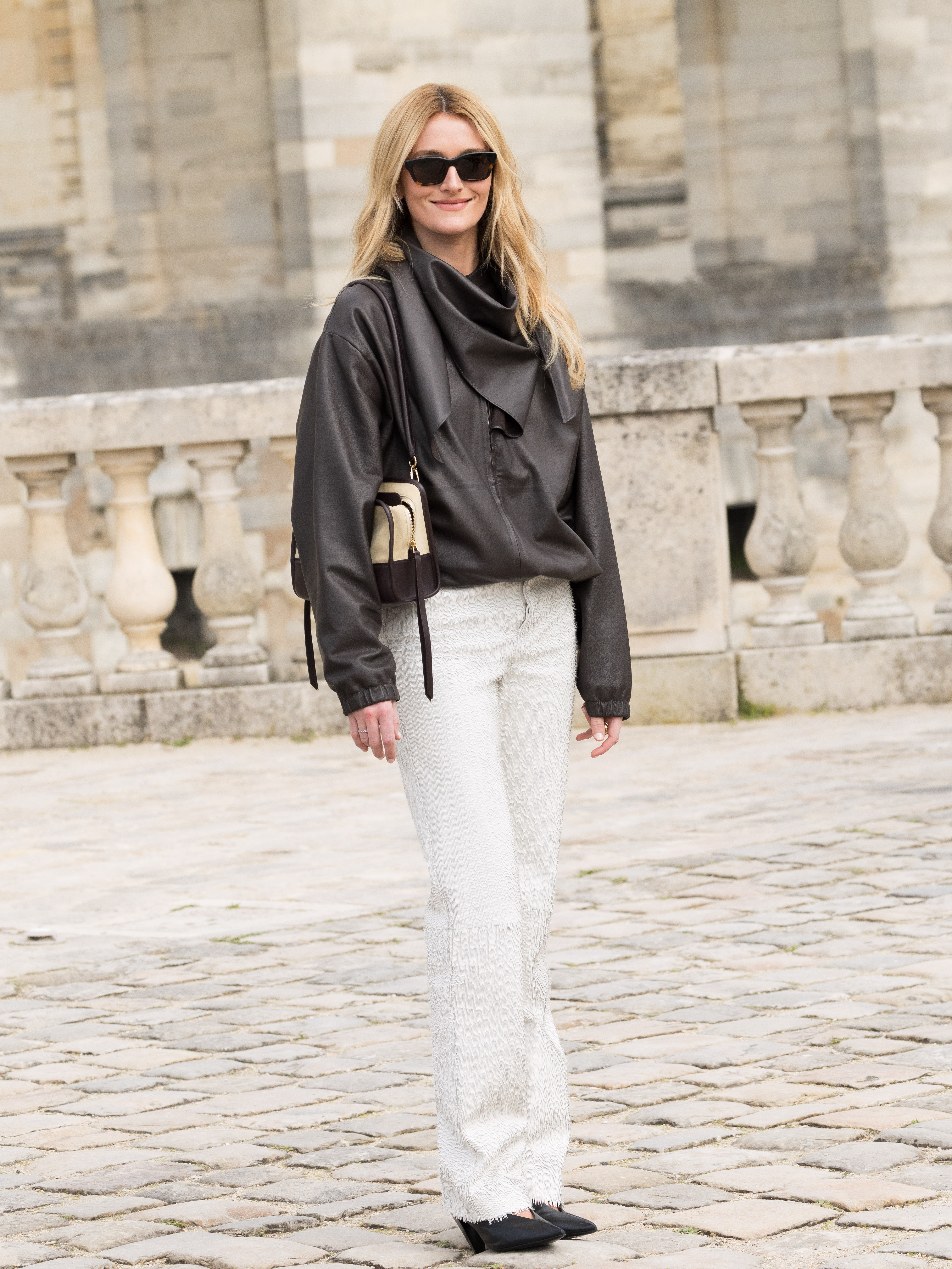 Ani mage of Sarah Pidgeon wearing white jeans, one of the biggest spring 2026 denim trends, whilst attending the Loewe show during Paris Fashion Week.