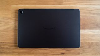 The back of an Amazon Fire Max 11 tablet on a wooden surface