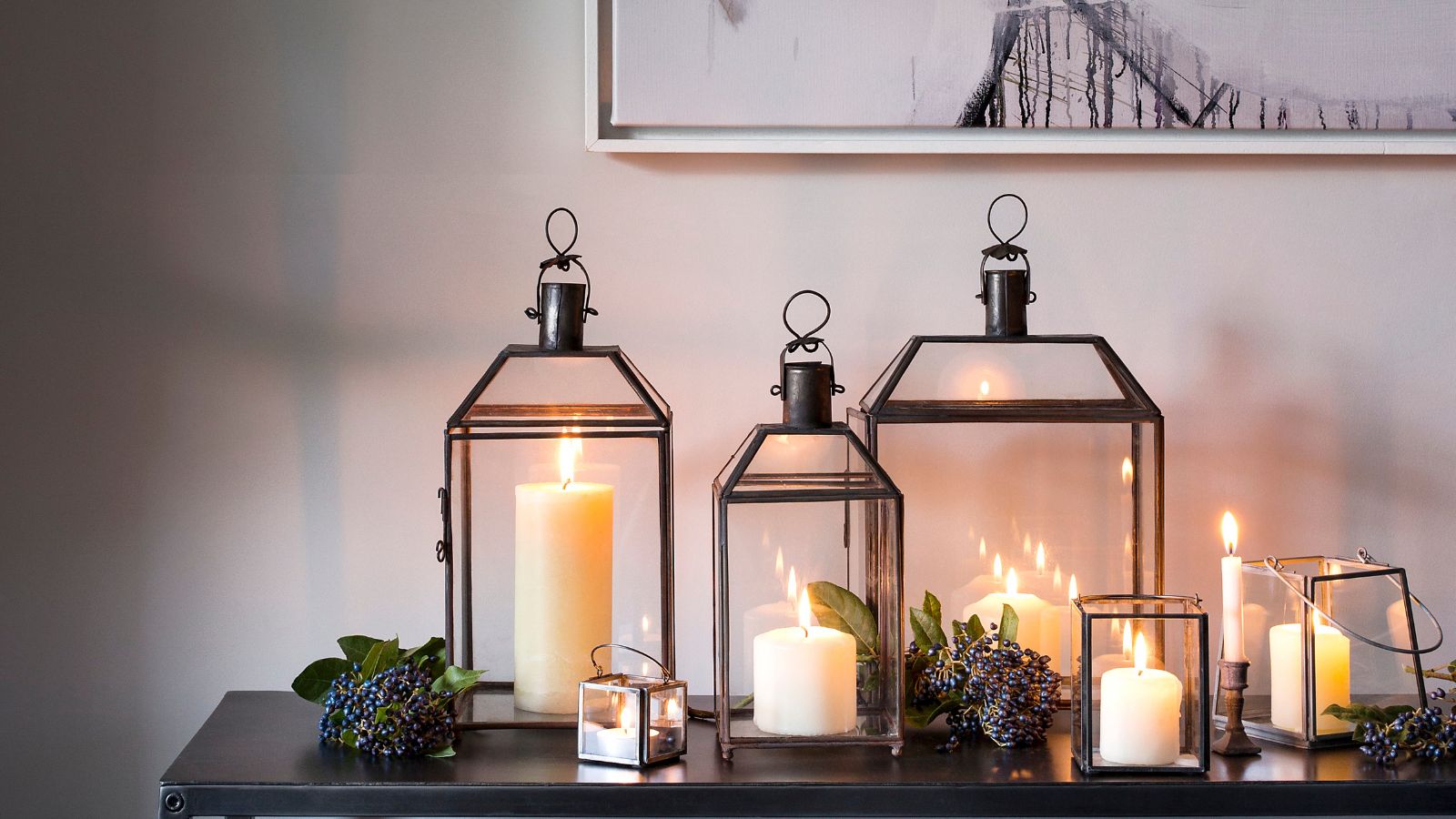 Pillar candles in black-rimmed glass lanterns