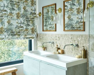 Modern country bathroom with double sink, neutral textured tiled backsplash and tree design window blind