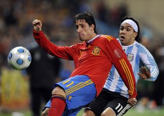 Span's Joan Capdevila competes for the ball with Argentina's Carlos Tevez in a friendly in 2009.