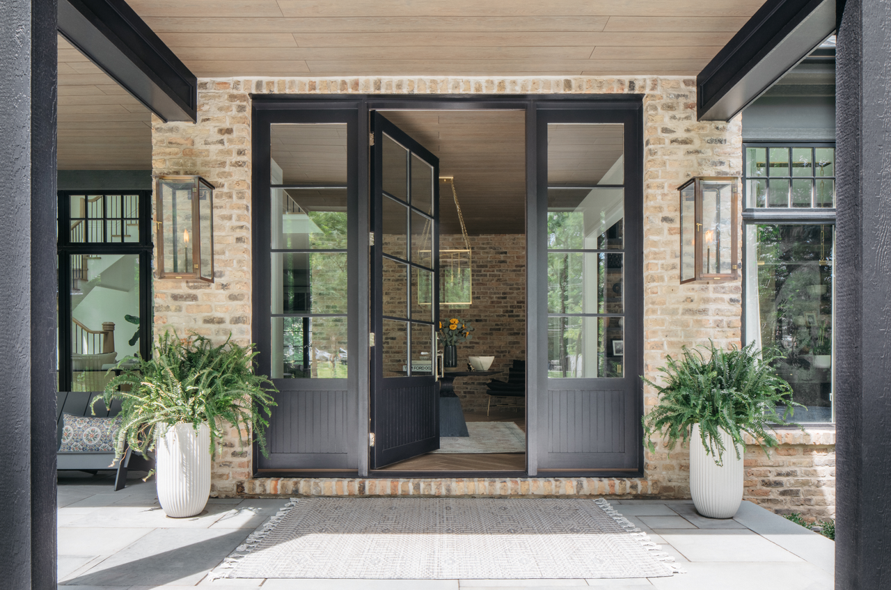 Oversized black wooden front doors with windows