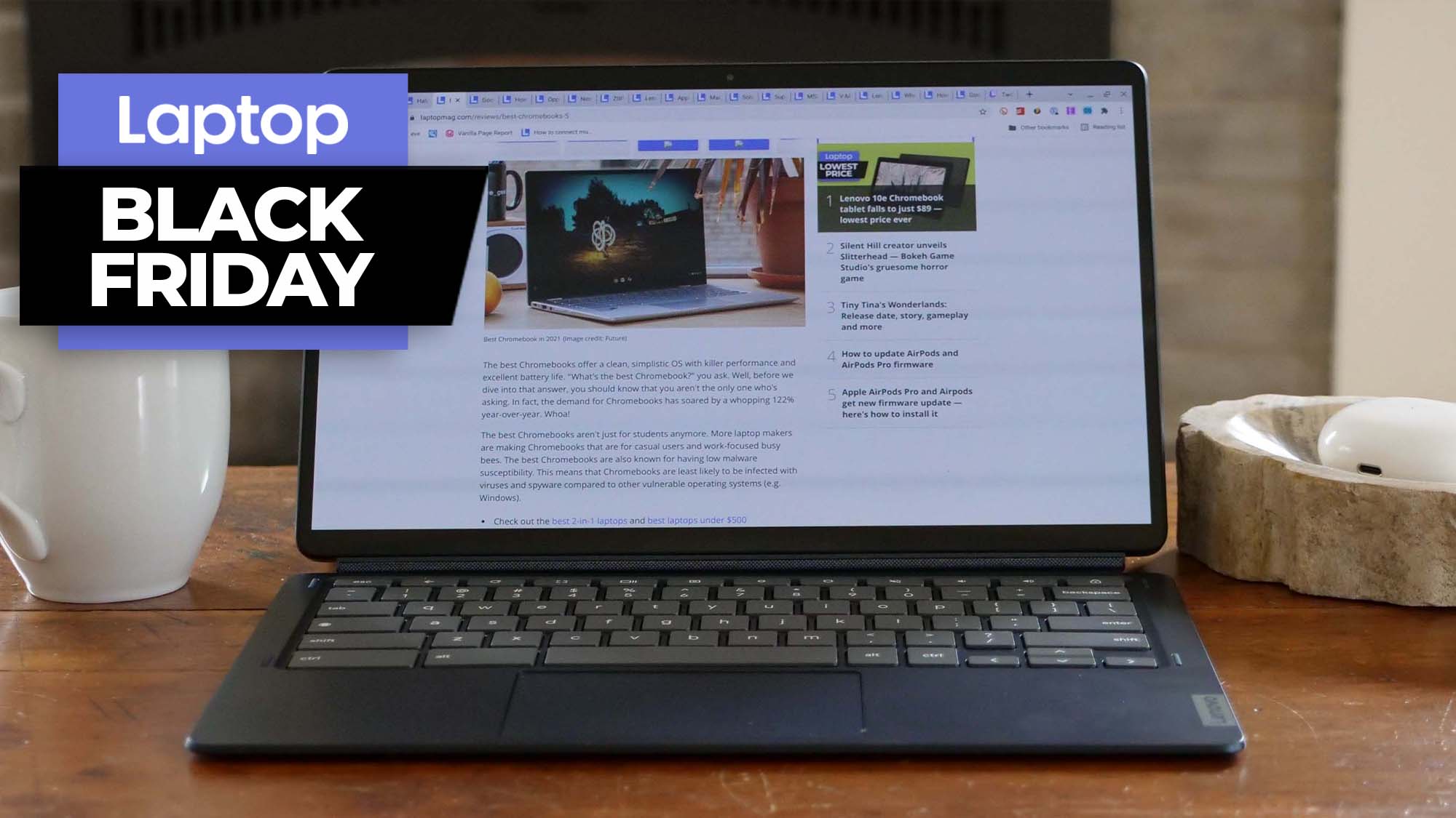 Lenovo IdeaPad Duet 5 Chromebook open on a coffee table with a mug to its left and a Black Friday banner overlapping it