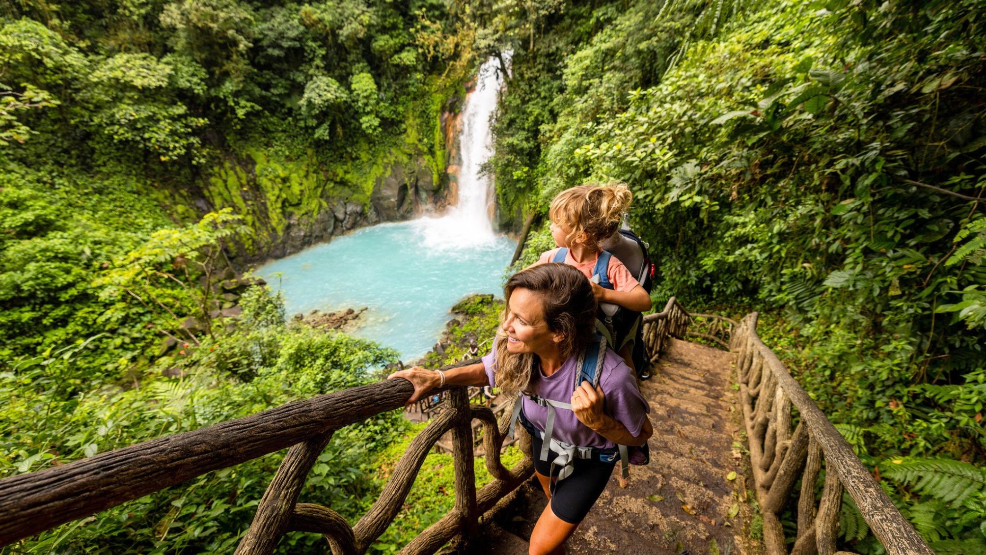 A family hiking at Rio Celeste waterfall in Costa Rica.