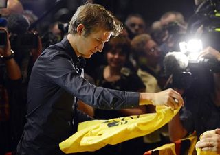 Andy Schleck signs shirts for the fans
