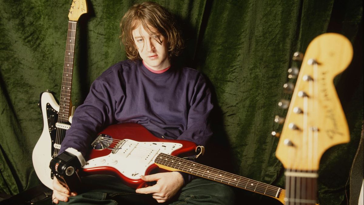 Kevin Shields of My Bloody Valentine poses with a collection of Fender Jazzmaster and Fender Jaguar guitars, London, 1990