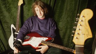 Kevin Shields of My Bloody Valentine poses with a collection of Fender Jazzmaster and Fender Jaguar guitars, London, 1990