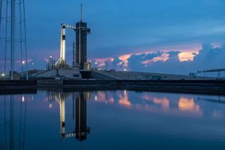 The sun sets behind a SpaceX Falcon 9 rocket on Launch Complex 39A at the Kennedy Space Center in Florida for the last time before the rocket's planned launch of two NASA astronauts to the International Space Station. The Falcon 9 rocket, topped with SpaceX's Crew Dragon spacecraft, is set to launch the Demo-2 mission from this historic launch pad today at 4:33 p.m. EDT (2033 GMT), weather permitting. On board will be Bob Behnken and Doug Hurley, who will become the first NASA astronauts to travel to the International Space Station in a commercial spacecraft. SpaceX founder Elon Musk tweeted this photo on Tuesday night (May 26).