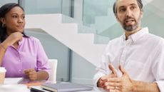 Two business people sitting at a table having a discussion