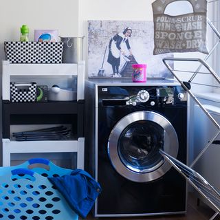 room with washing machine and shelves