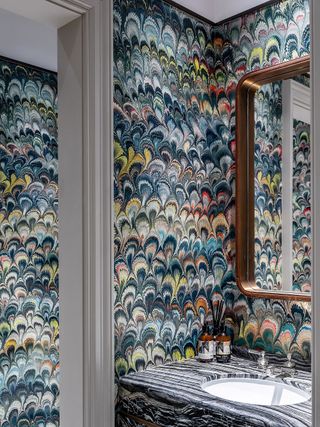 cloakroom with brightly colored and patterned wallpaper
