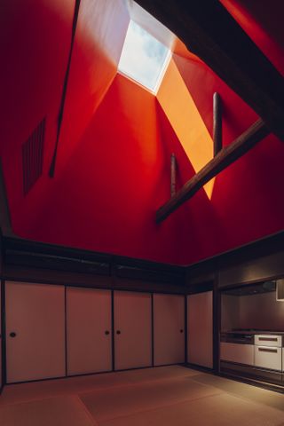 Red ceiling with square skylight at the Suzu apartment building renovation