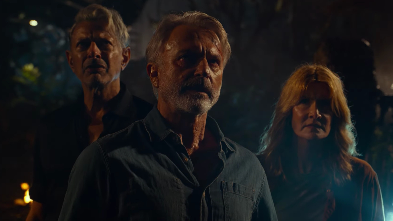 Jeff Goldblum, Sam Neill, and Laura Dern stand together in concern in Jurassic World: Dominion.