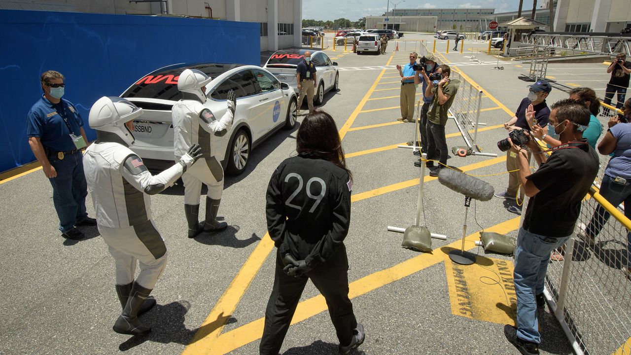 NASA astronauts Bob Behnken and Doug Hurley walk out of NASA's Astronaut Crew Quarters and take a Tesla Model X to Launch Pad 39A during a dry-run test of their SpaceX Crew Dragon Demo-2 flight on May 23, 2020 at the Kennedy Space Center in Florida.