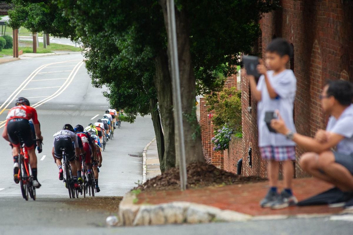 The mens field goes single file again to chase a group up the road during the road race at the Winston-Salem Cycling Classic