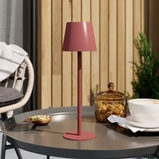 GoodHome Quelea Matt Red Integrated LED Table lamp on a garden coffee table