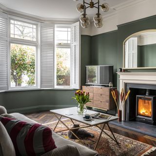 Fireplace next to bay window in living room