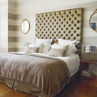 bedroom with wooden flooring and grey strip wall