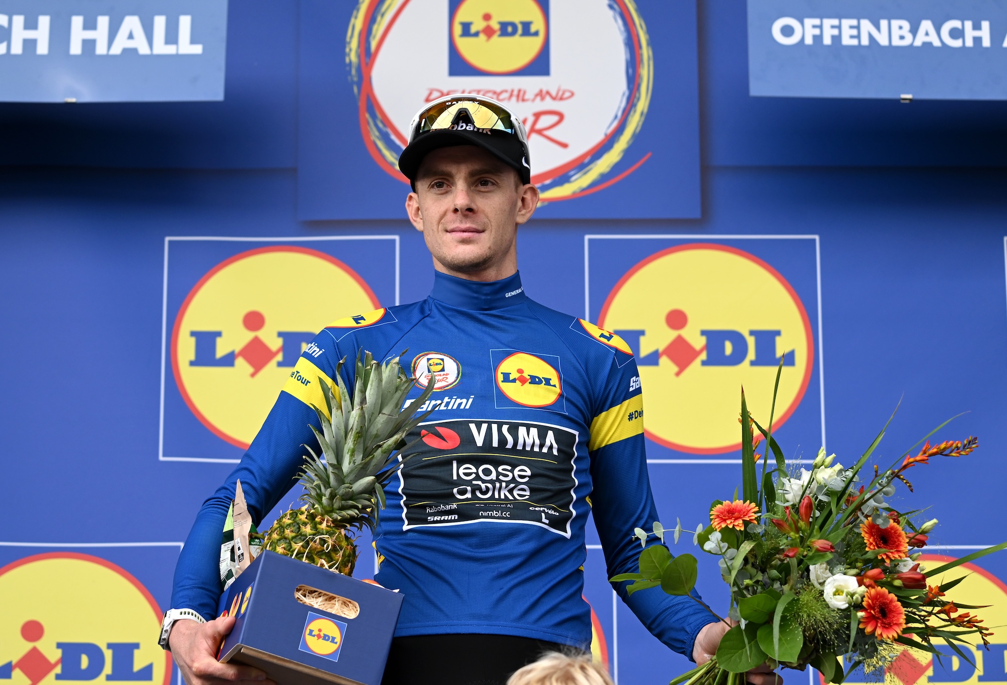 Louis Barr&amp;eacute; of Visma-Lease a Bike celebrates at podium in Blue Leader Jersey after stage 2