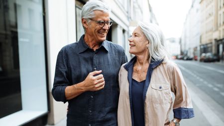 Senior couple walking around the city