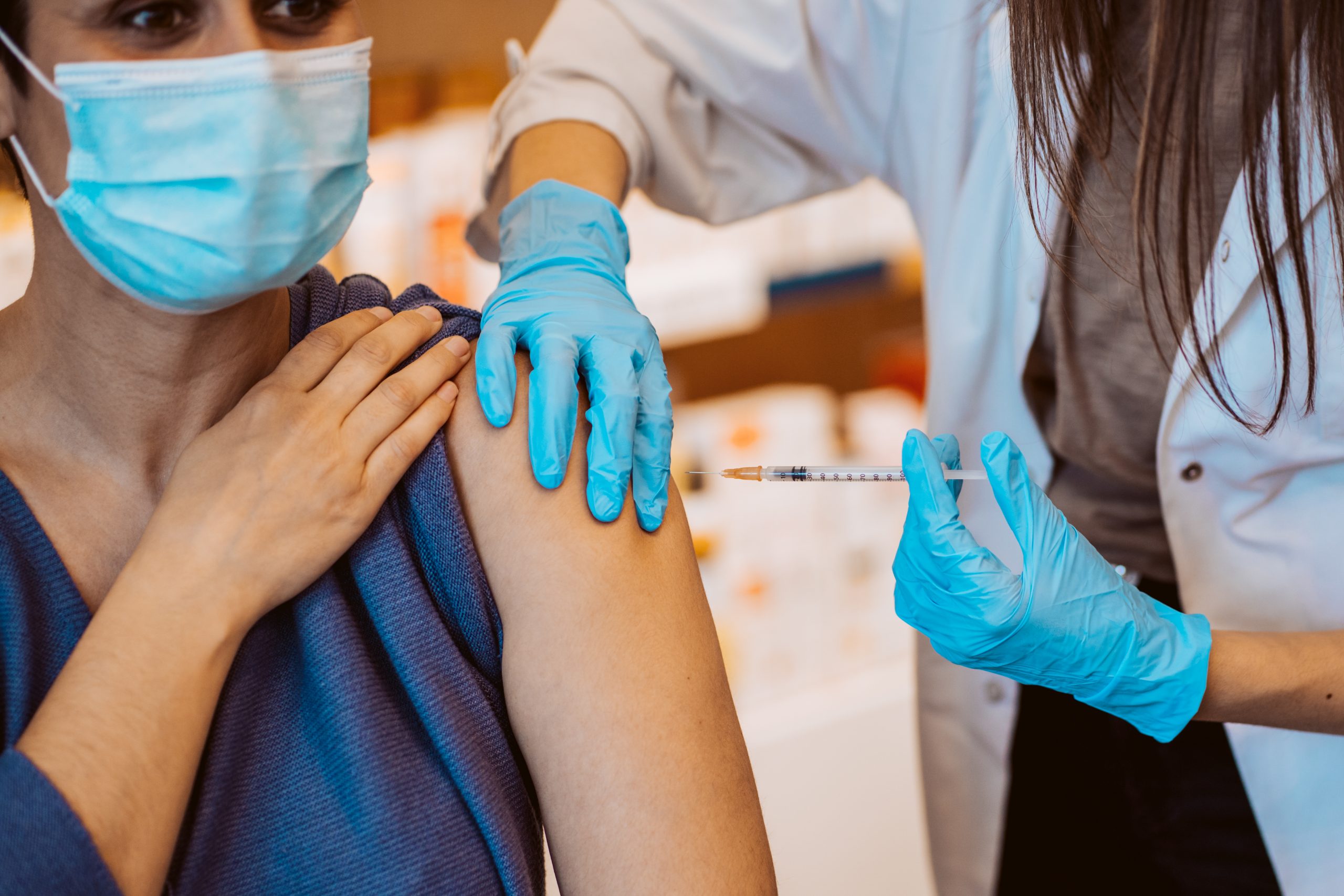 Young woman getting the flu vaccine as she finds out where to get the flu vaccine in the local area