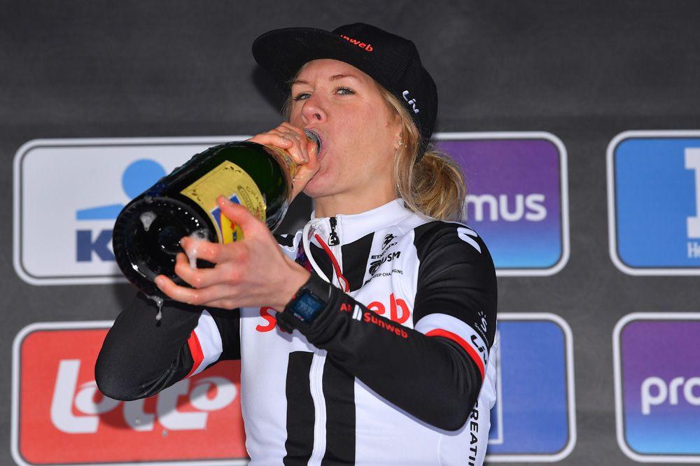 Ellen van Dijk takes a swig of champagne