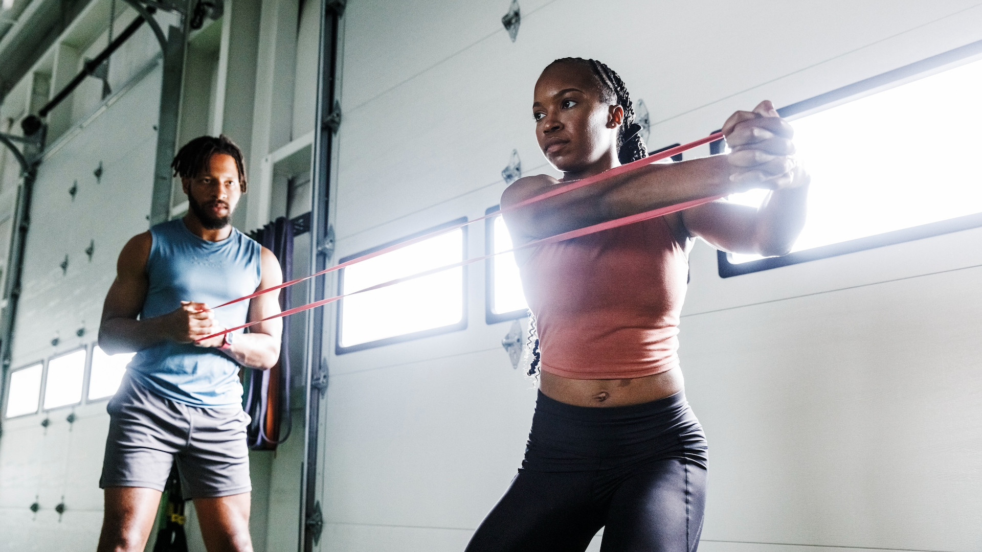 Woman doing a personal training session with a resistance band
