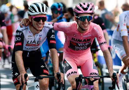 Adam Yates (l) celebrates with Simon Yates' (r) as his brother heads towards victory in the 2025 Giro d'Italia