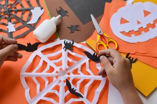 A child enjoying making Halloween themed arts and crafts.