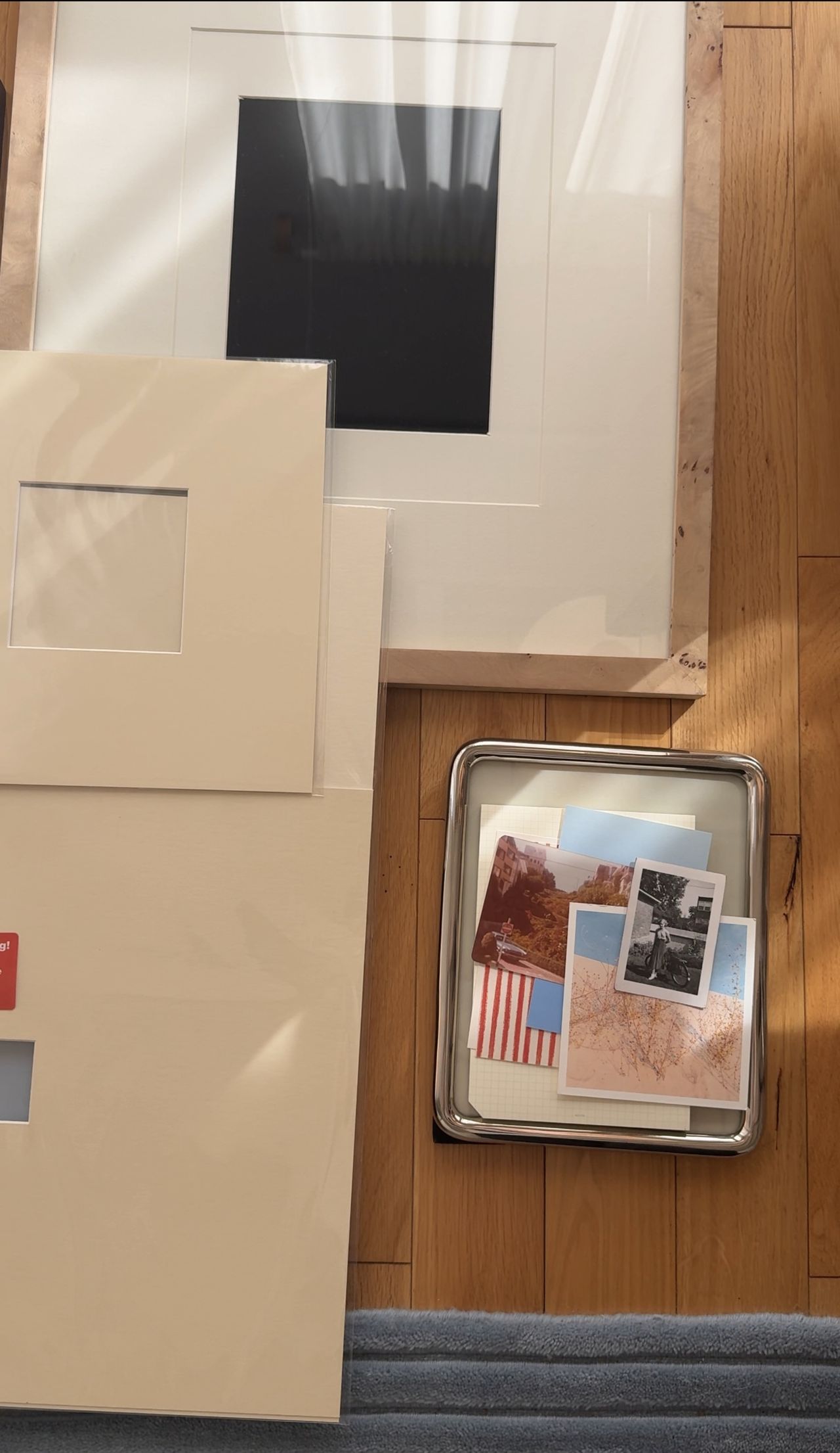 Image of a different size mat boards and picture frames laying on a hardwood floor