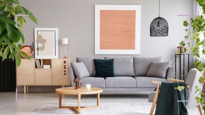 modern living room with gray sofa, art work and wooden side tables