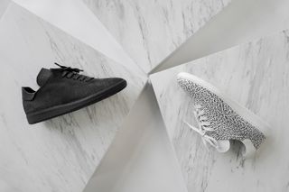 Black trainer and black and white speckled trainer