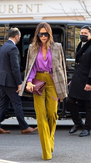 Victoria Beckham in wide-leg mustard-coloured trousers